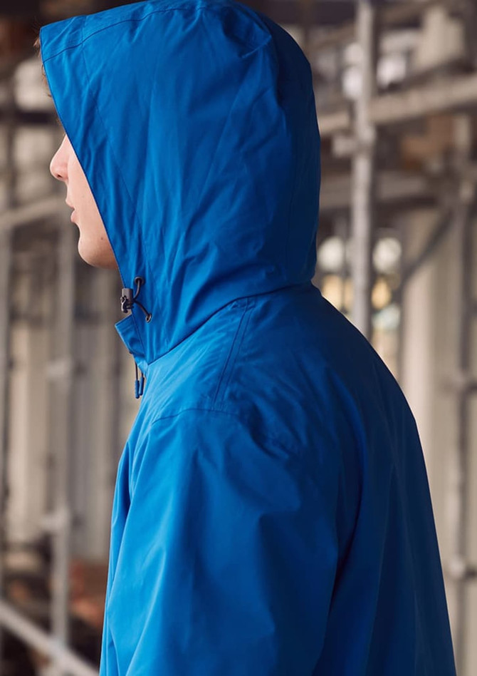A blue unisex super light packable rain jacket with a hood, featuring a logo, displayed on a model from the side.