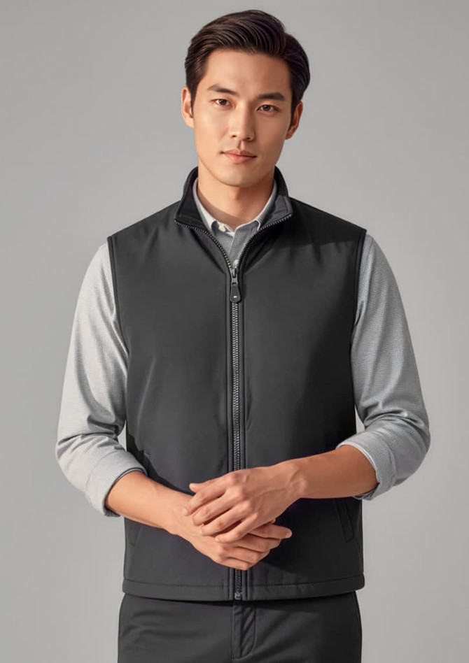 A black unisex reversible fleece vest displayed on a model, featuring a zip-up front and a simple design.