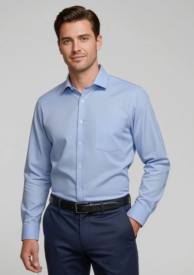 A light blue button-up shirt with long sleeves, featuring a single chest pocket and a collar, worn by a model.