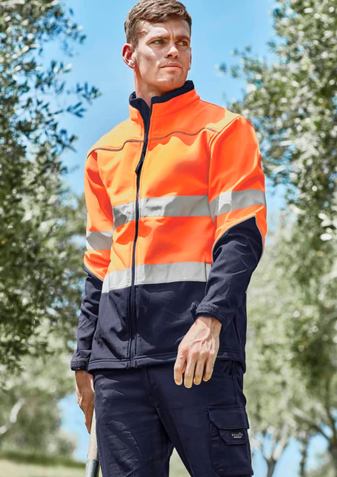 A unisex hi-vis softshell jacket in bright orange and navy, featuring reflective stripes and a logo on the chest.