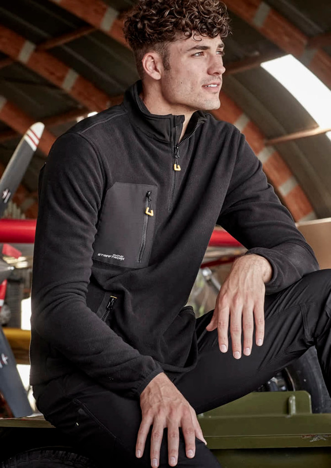 A unisex black lightweight 1/4 zip polar fleece featuring a front pocket and a logo. Suitable for workwear and outdoor use.