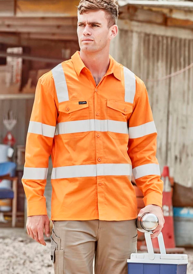 An orange long sleeve shirt with reflective stripes and a logo, worn by a man holding a drink bottle.