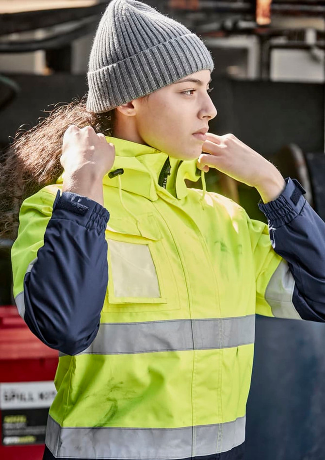 A waterproof jacket in hi-vis yellow with navy sleeves, featuring reflective stripes and a logo.