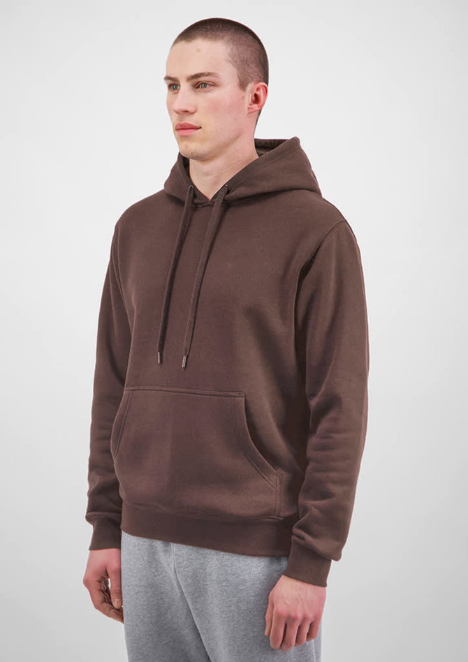 A brown hoodie with a front pocket and drawstring hood, modelled by a man wearing grey sweatpants.