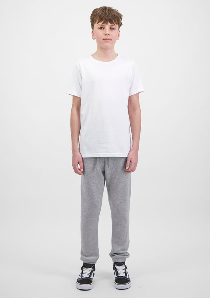 A pair of grey track pants with ribbed cuffs, displayed on a model wearing a white t-shirt and black shoes.
