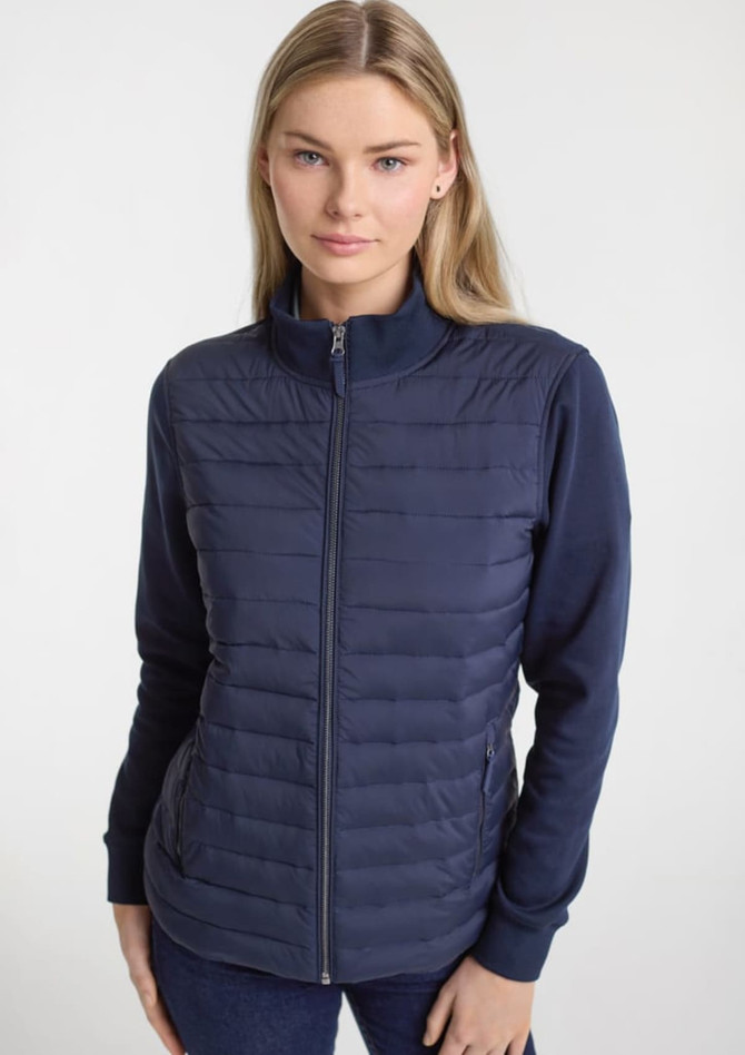 A women's tailor jacket in navy, featuring a zip front and a combination of padded and smooth fabric.