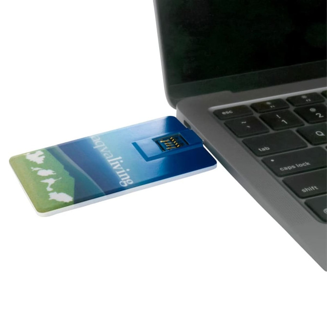 A slim, blue credit card-sized Type-C flash drive is connected to a laptop. It features a logo on its surface.