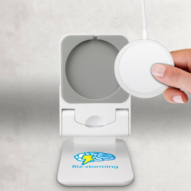 A white magnetic wireless charger with a logo, featuring a round charging pad and a hand holding a device.
