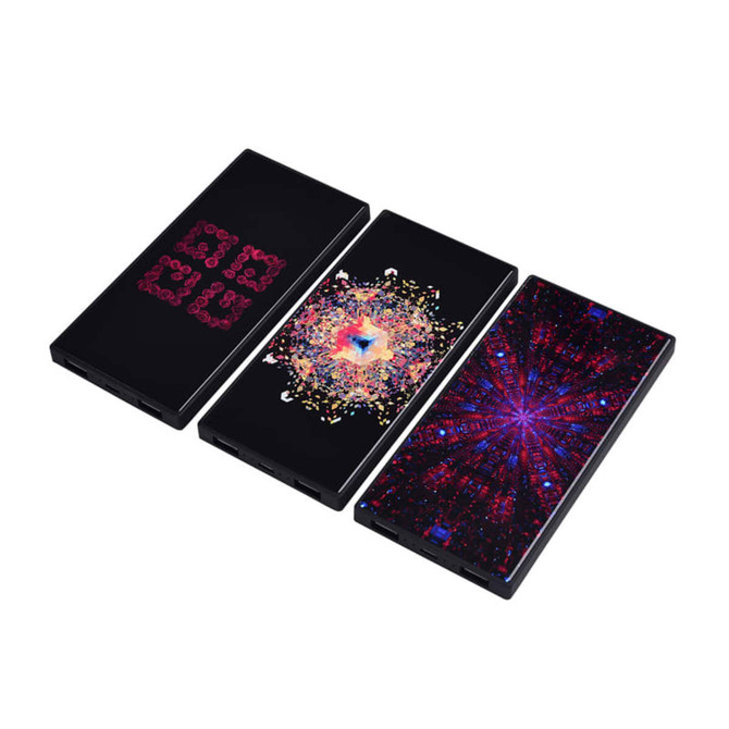Three black power banks with vibrant, multicoloured abstract designs. Each features a unique pattern.