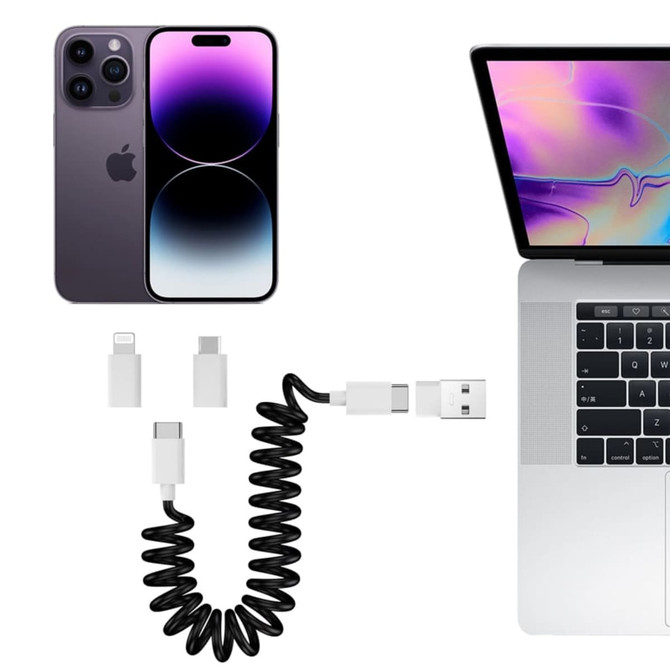 A coiled black charging cable kit with USB, Type-C, and Lightning connectors, alongside a smartphone and a laptop.