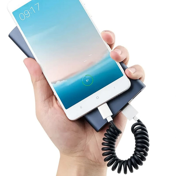 A Type-C charge cable kit in black, connecting a smartphone to a power bank in a hand.