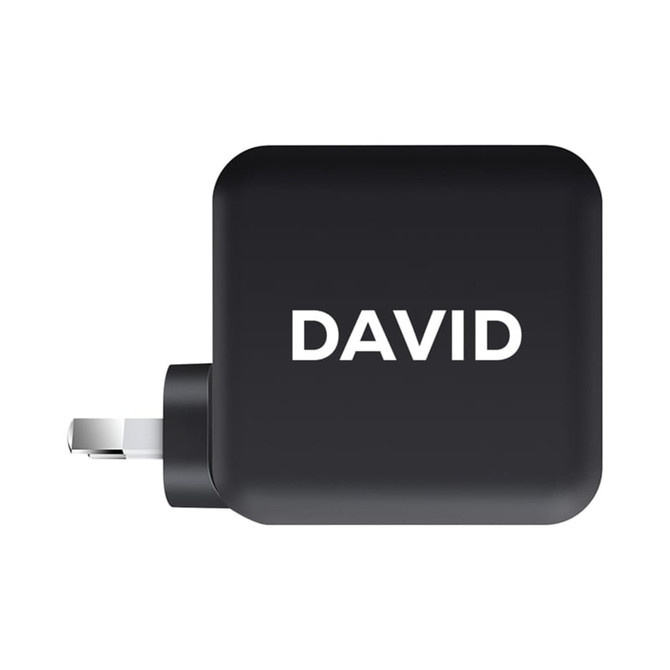 A black 100 Watt GaN quick charger with a plug and a branding logo on the side.