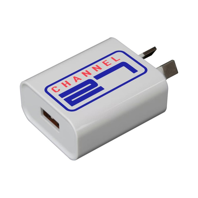 A white USB wall charger with a branded logo, featuring a single USB port and foldable prongs.