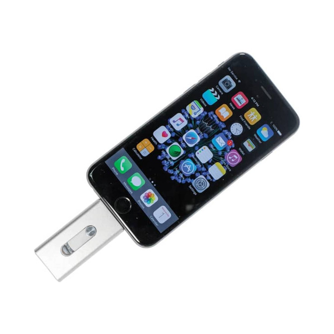 A silver OTG USB 3.0 flash drive is connected to a black smartphone displaying various app icons.