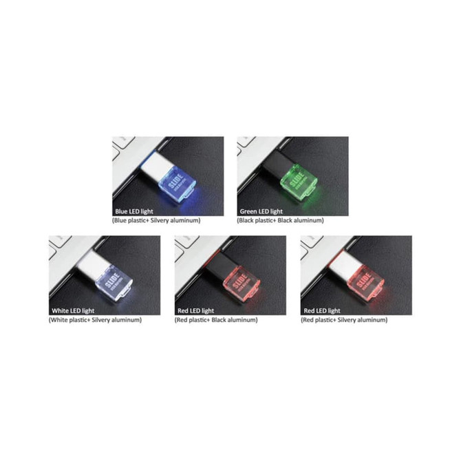 A collection of four flash drives in various colours: blue, green, white, and red, with different LED light indicators.
