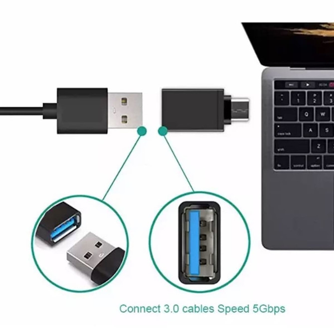 A black USB 3.0 to Type-C adapter connected to a laptop, featuring a logo on the adapter's casing.