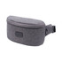 A grey sling bag with a smooth, rounded design, featuring a buckle strap and a logo.