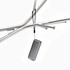 A compact black Bluetooth speaker hanging from a metal frame, featuring a sleek design and a strap.