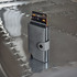 A grey vegan wallet stands upright on a metallic surface, displaying multiple cards partially visible from its opening.