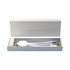 A white gift box containing a charging cable and a round device, with a sleek design and a branding logo.