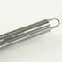 A stainless steel BBQ tool featuring a hanging loop and branded with a logo.