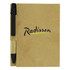 A brown recycled notebook with a black pen attached, featuring a logo on the front cover.