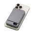 A grey Eco Magnetic Wireless Power Bank atop a smartphone, featuring a sleek, compact design and a logo.