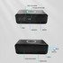 A black wireless charging speaker featuring a clock display, stopwatch, speaker, and mobile phone holder.