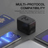 A travel adaptor in black with multiple ports, set against a backdrop of a passport and electronic devices.