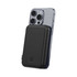 A black magnetic power bank is attached to a smartphone, showcasing its slim design and built-in charging capabilities.
