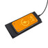 A wireless charging mouse pad in black with a smartphone displaying a charging indicator on top.