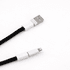 A black charging lanyard with white connectors at both ends, featuring a USB and a Lightning connector.