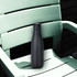 A drink bottle in matte black, made from copper vacuum insulation, rests on a green outdoor chair.