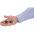 A hand holding a pair of black true wireless Bluetooth earbuds beside a striped shirt sleeve.