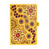 A yellow patterned journal with Aboriginal-inspired designs, featuring vibrant flowers and circular motifs, with a logo.