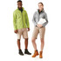 A men's green softshell jacket and a woman's grey softshell jacket, both featuring branding, displayed with shorts and boots.