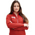 A woman wearing a red knit jacket with a zippered front and a logo on the chest.