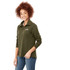 A woman's green knitted jumper featuring a half zip and a logo. It has a relaxed fit and long sleeves.