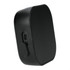 A black Bluetooth speaker with a textured front, featuring a charging port on the side and a logo on the surface.