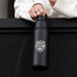 A drink bottle in matte black with a logo, featuring a twist lid and a durable design.