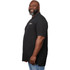 A man in a black polo shirt with a logo, standing with a smile and facing left. The shirt has a longer cut.