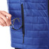 A blue lightweight packable insulated puffer jacket with a hand retrieving an item from a side pocket.