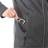 A grey softshell jacket with a hand reaching into a zippered pocket, featuring a pull tab.
