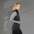A lightweight packable insulated puffer vest in black, featuring a sleek design and a high neckline.