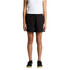 Black track shorts with a relaxed fit, featuring an elastic waistband and side pockets. Model is standing.