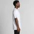 A side view of a man wearing a white Staple Raglan Tee, featuring a relaxed fit and short sleeves.
