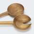 Two wooden salad servers in natural brown hues, featuring a spoon and a fork design, resting on a light background.