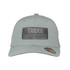 A grey trucker cap featuring a black rectangular patch with a logo, designed for outdoor adventures.