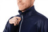 A navy blue performance jacket with a full zip and thumb holes, featuring a textured design and a collar.
