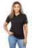 A woman wearing a black eco-friendly polo shirt, featuring a logo on the sleeve and styled with jeans.